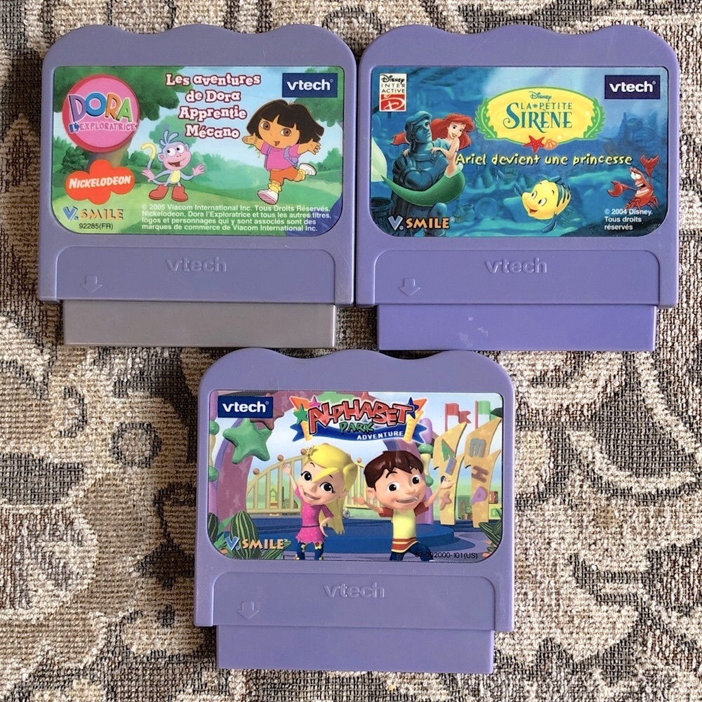 3 V-Tech V -Smile Games: Top two are French, bottom one is English.